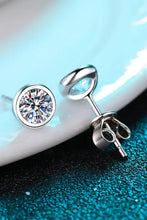 Sterling silver stud earrings with clear gems, blue accents, limited warranty included