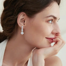 Sterling silver drop earrings with three-stone round brilliant diamonds