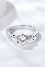 Sterling silver engagement ring with round brilliant-cut diamond and baguette side stones symbolizing loyal love