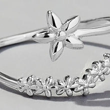 Sterling silver flower ring with adjustable floral wrap-around bangle design