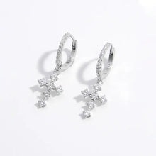 Sterling silver hoop earrings with dangling cubic zirconia cross charms