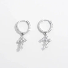 Sterling silver hoop earrings with dangling cubic zirconia cross charms