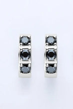 Sterling silver huggie earrings with inlaid black moissanite in minimalist design