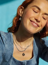 Smiling woman in alloy inlaid zircon sun and moon necklace with amber