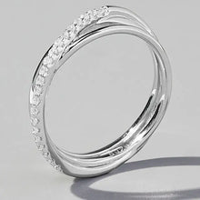 A silver-toned twisted band ring with pave-set white diamonds on one side.