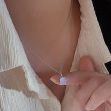 Delicate sterling silver necklace with iridescent blue-white gemstone pendant