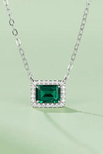 Sterling silver necklace with emerald rectangle pendant and diamond accents