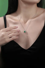Sterling silver necklace with lab-grown emerald oval pendant and matching box