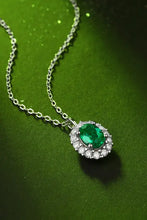 Sterling silver necklace with lab-grown emerald oval pendant and diamonds