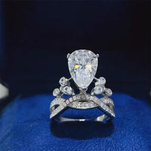 Sterling silver pear cut diamond engagement ring with pavé band