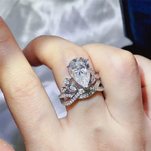 Sparkling sterling silver pear cut diamond ring with pavé band