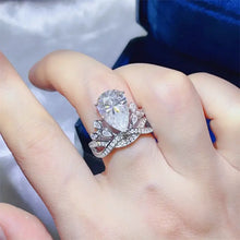 Sparkling 1 carat moissanite pear-cut sterling silver ring with pavé band