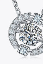 Sterling silver moissanite pendant with central round diamond and accent stones
