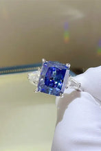 Princess cut sapphire sterling silver ring with trillion side stones