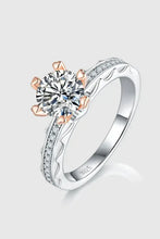 Sterling silver ring with carat moissanite in rose gold prongs