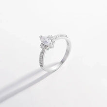 Sterling silver ring with inlaid zircon and pave side stones