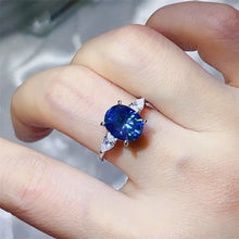 18k white gold sterling silver ring with oval blue sapphire and pear side stones