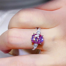 Oval-cut pink-purple 1 carat moissanite sterling silver ring with pear side stones