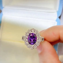 Sterling silver ring with oval purple gemstone and carat moissanite halo