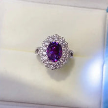 Sterling silver ring with oval purple gemstone and carat moissanite halo