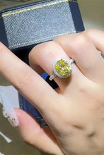 Sterling silver ring with oval yellow diamond halo and pavé band