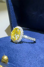 Oval yellow diamond sterling silver ring with white diamond halo