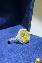 Sterling silver ring with oval yellow diamond and white diamond halo