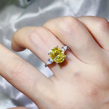 Oval-cut yellow diamond sterling silver ring with pear side stones