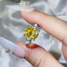 Sterling silver ring with oval yellow gemstone and pear side stones