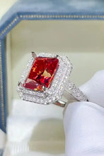 Sterling silver ring with radiant-cut red gemstone and double halo of white diamonds