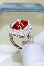 Sterling silver ring with cushion-cut red gemstone and double halo diamonds