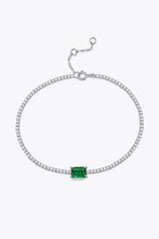 Sterling silver tennis bracelet with lab-grown emerald center stone