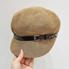 Light brown straw woven buckle hat with black leather-look strap