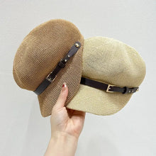 Two straw woven buckle hats with dark brown faux leather straps