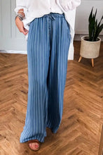 Stripe chambray wide leg jeans in blue and white with tied elastic waist and vertical stripes for casual wear