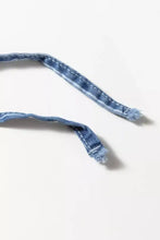 A frayed blue denim drawstring with white stitching on stripe chambray wide leg jeans featuring a tied elastic waist