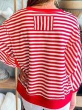Back view of red and white striped long-sleeved stripe christmas nutcracker sequin patched top for casual holiday wear