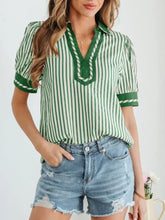 Green and white vertically striped short bubble sleeve blouse with v-neckline and green trim for casual wear