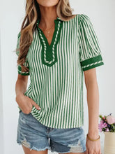 Green and white vertically striped short bubble sleeve blouse with v-neckline and green trim for casual wear