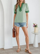 Green and white vertically striped short bubble sleeve blouse with green embroidered collar and split neck detail