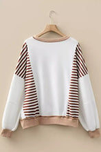 White and brown striped long-sleeved sweatshirt with beige trim featuring machine wash cold care instructions