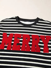 Black and white striped slightly stretchy sweatshirt with bold red merry lettering care instructions tumble dry safe