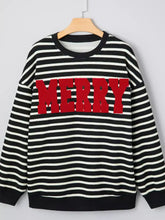 Black and white striped slightly stretchy sweatshirt with bold red merry lettering care instructions tumble dry