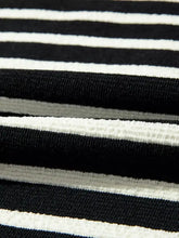 Black and white horizontally striped slightly stretchy ribbed knit fabric on stripe contrast merry letter christmas print drop shoulder sweatshirt with tumble dry care instructions