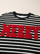 Black and white striped slightly stretchy long-sleeved sweatshirt with bold red merry lettering tumble dry care instructions