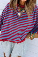 Oversize red and blue striped sweatshirt with scalloped hem and exposed seams, slightly stretchy and machine wash care instructions