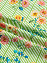 Stripe floral ruffle short sleeve blouse with bright green and white stripes and colorful floral pattern