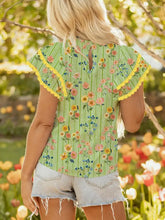A vibrant green and yellow stripe floral ruffle short sleeve blouse with scalloped detail and ruffled sleeves