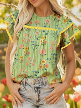A vibrant green stripe floral ruffle short sleeve blouse with yellow ruffled sleeves and matching trim across chest