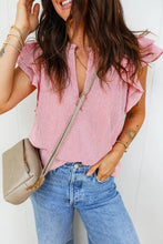 A beige crossbody bag with gold-tone hardware paired with a stripe frilly double ruffled short sleeve blouse
